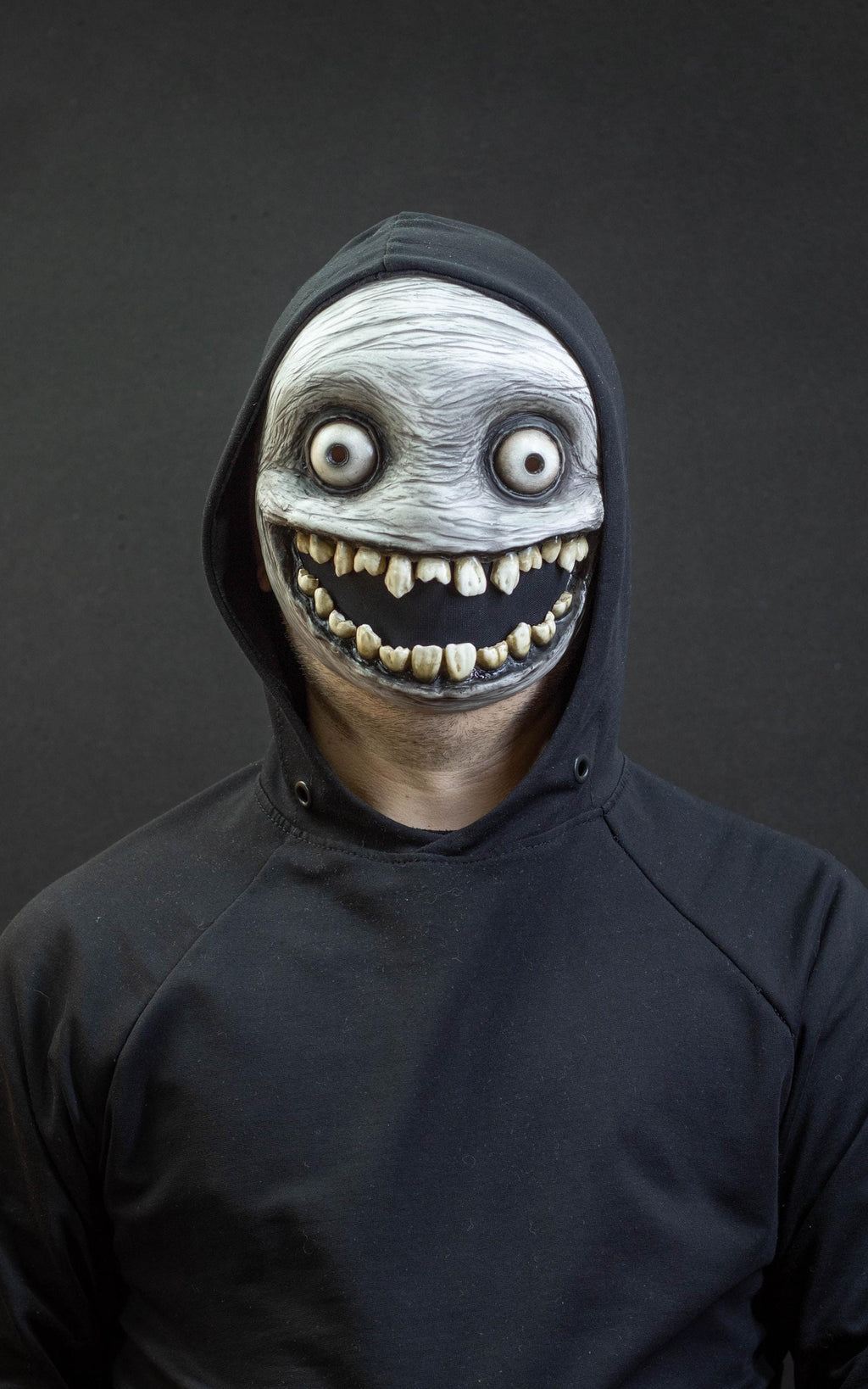 Crazy smile mask with bulging eyes for Halloween or a funny gift