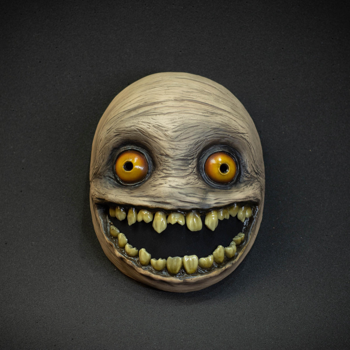 Crazy smile mask with yellow eyes for Halloween or a funny gift