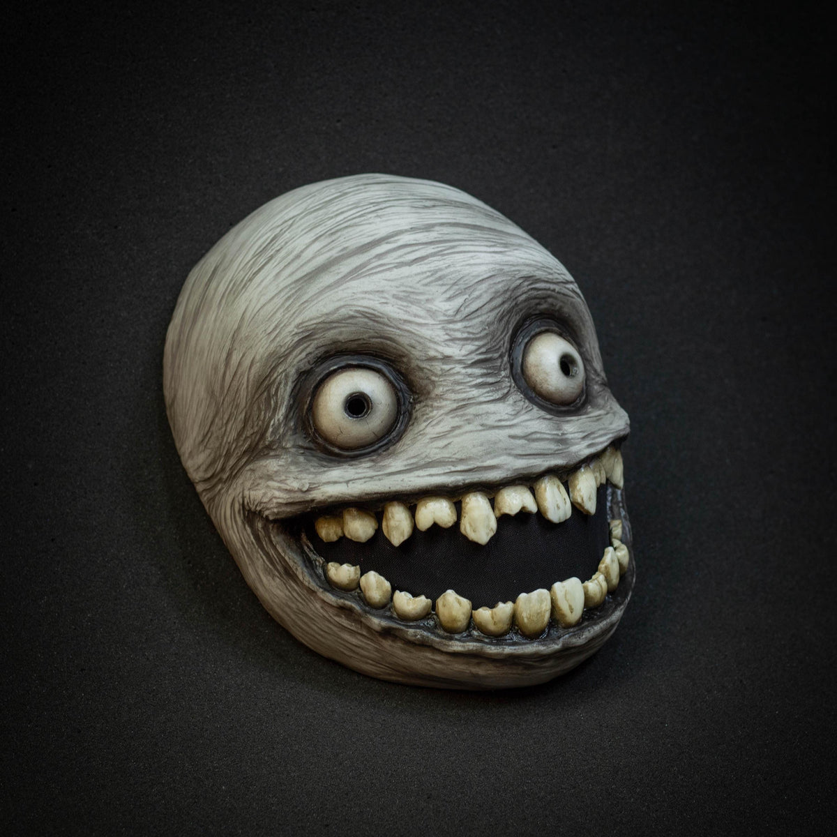Crazy smile mask with bulging eyes for Halloween or a funny gift