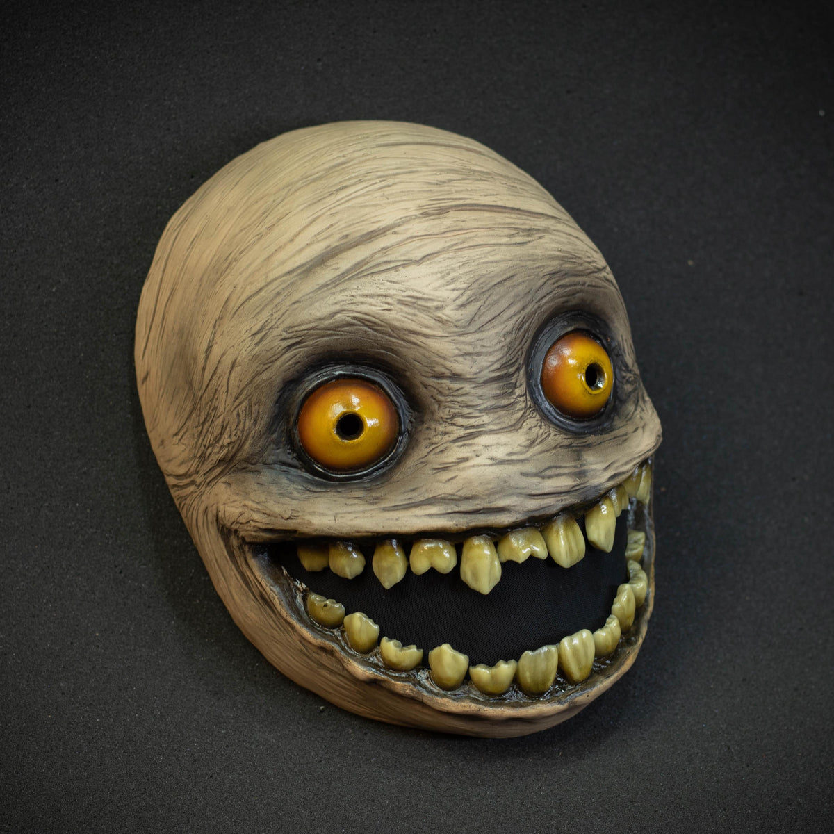 Crazy smile mask with yellow eyes for Halloween or a funny gift