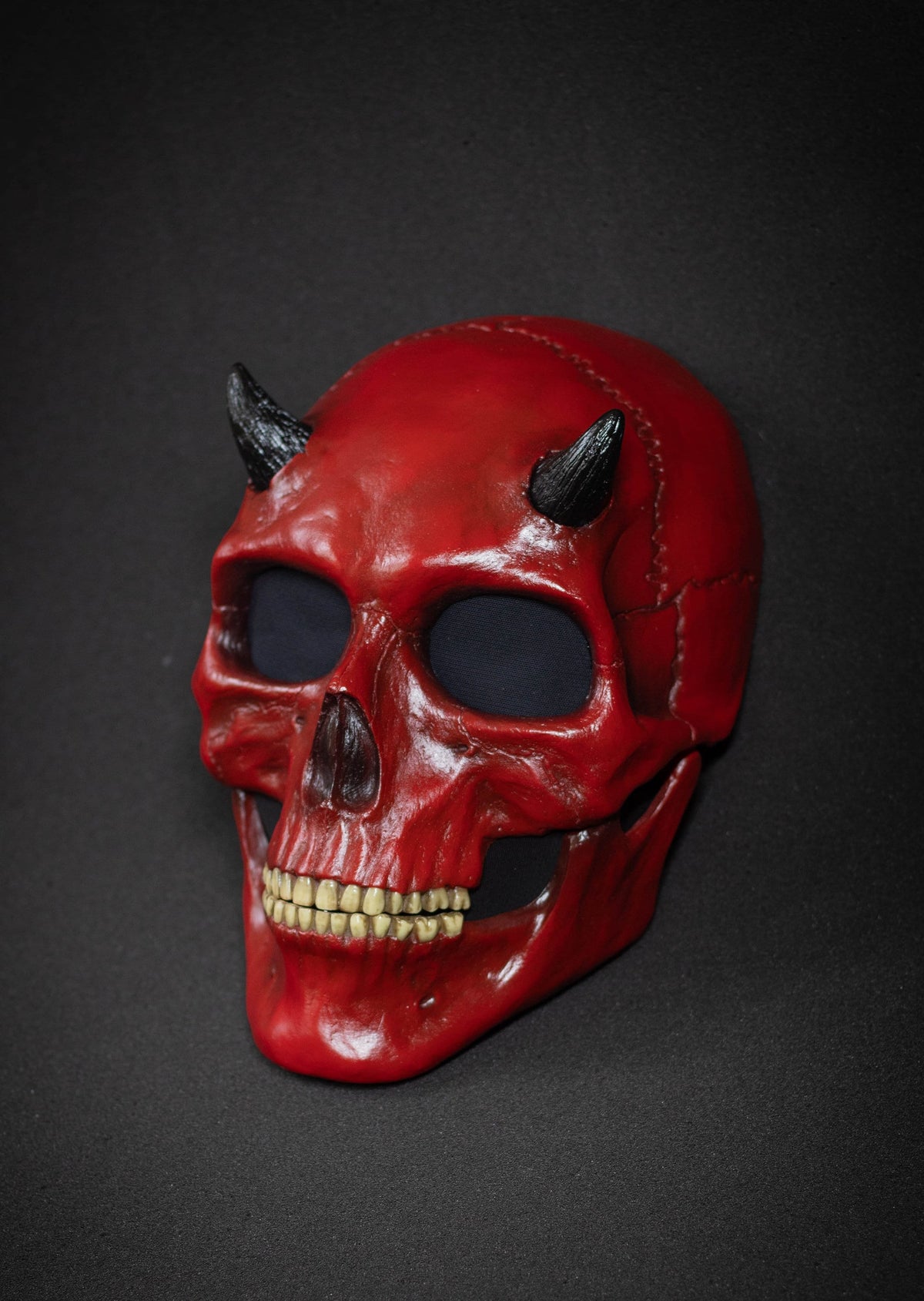 Human Skull mask with small black horns and red shape